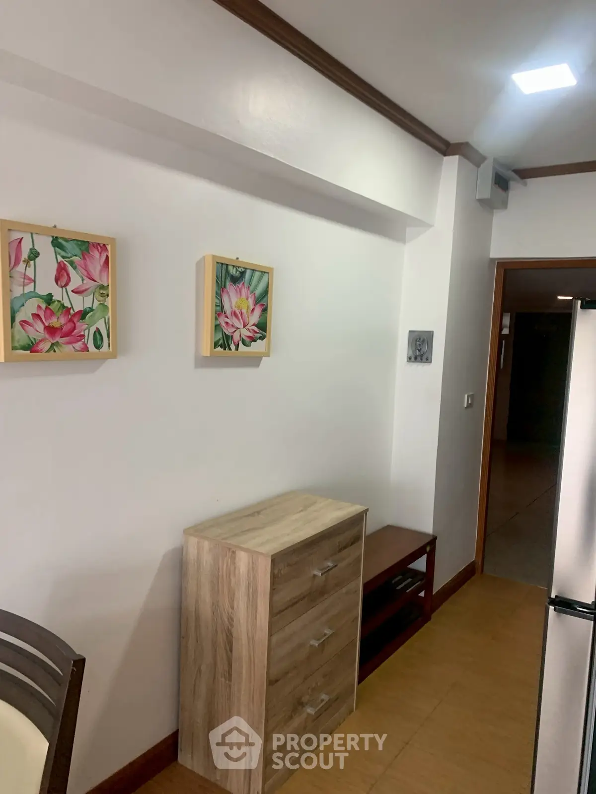 Cozy interior with modern furniture and floral artwork in a well-lit space.