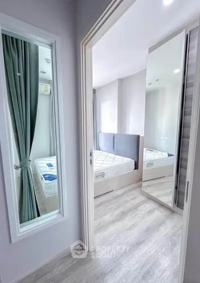 Modern bedroom with mirrored wardrobe and stylish decor