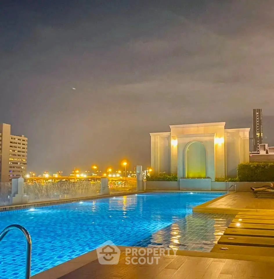 Luxurious rooftop pool with stunning city view at night