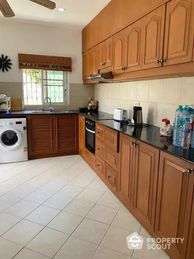 Spacious kitchen with wooden cabinets and modern appliances