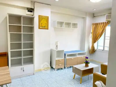 Bright living room with modern furniture and ample storage space