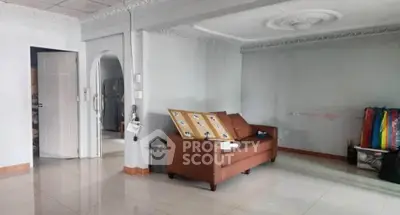 Spacious living room with modern sofa and elegant ceiling design in a bright, airy home.