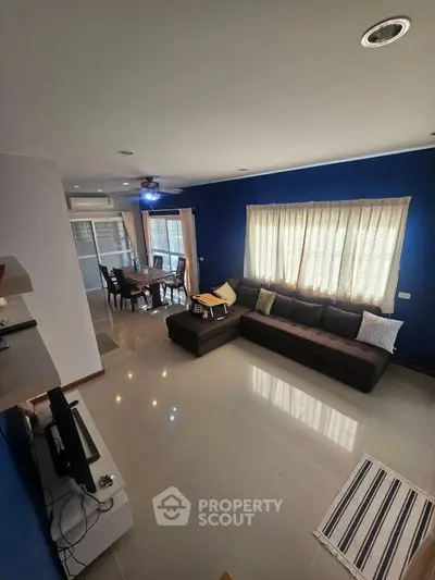 Spacious living room with modern decor and large windows in a stylish home