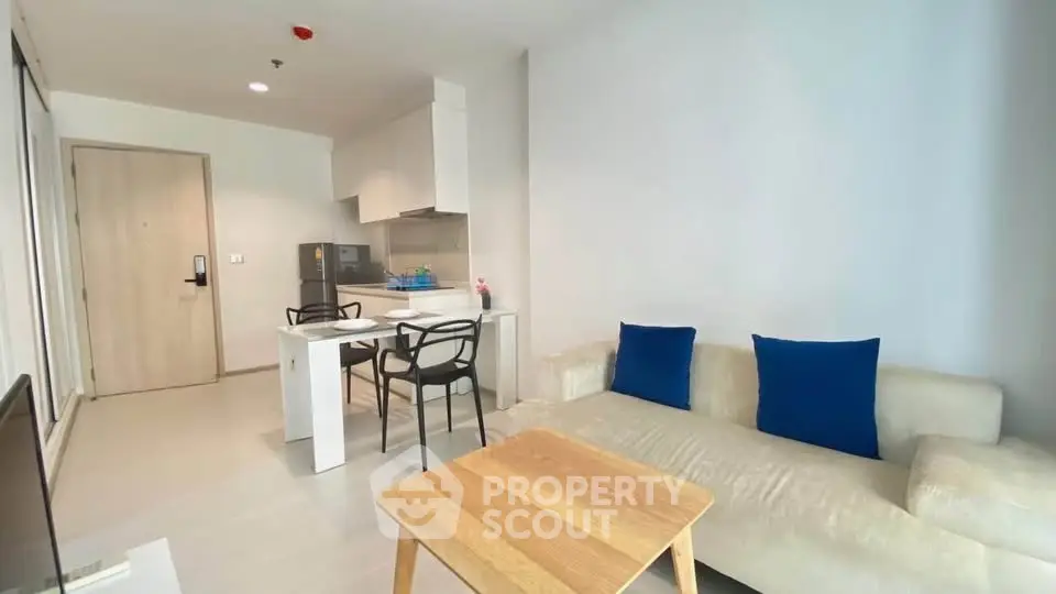 Modern living room with cozy sofa and dining area in open layout apartment