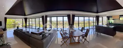 Luxurious open-plan living room with panoramic views and modern kitchen