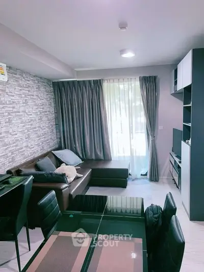 Modern living room with stylish decor and natural light, featuring a cozy sectional sofa and elegant dining area.