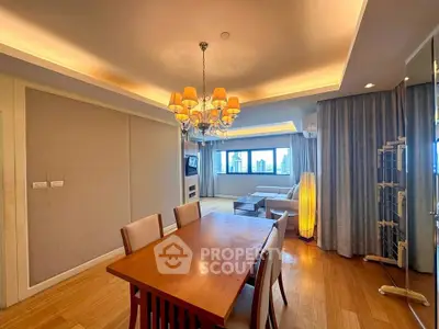 Spacious living room with elegant chandelier and city view