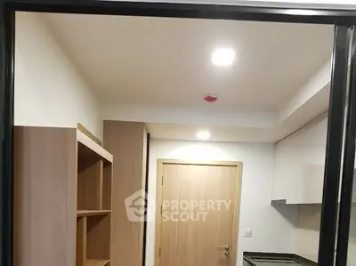 Modern kitchen with sleek cabinetry and recessed lighting in a contemporary apartment.