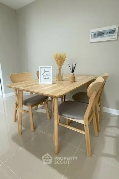 Chic dining area with modern wooden table and chairs, perfect for cozy meals.