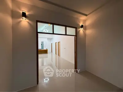 Spacious modern interior with sleek lighting and glossy floors, ideal for contemporary living.
