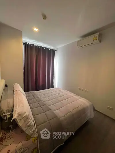 Cozy bedroom with modern decor and air conditioning in a stylish apartment.