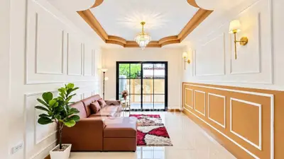 Elegant living room with stylish ceiling design and cozy brown sofa