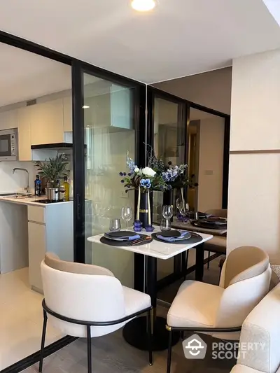 Modern dining area with elegant table setting and open kitchen view