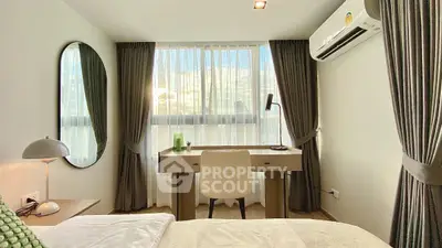 Modern bedroom with desk and large window, featuring elegant curtains and stylish decor.