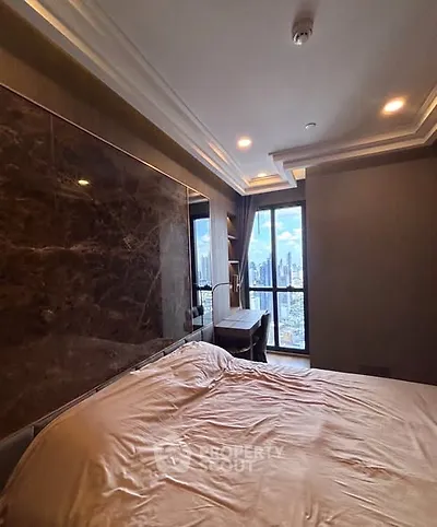 Luxurious bedroom with city view and elegant decor in high-rise apartment
