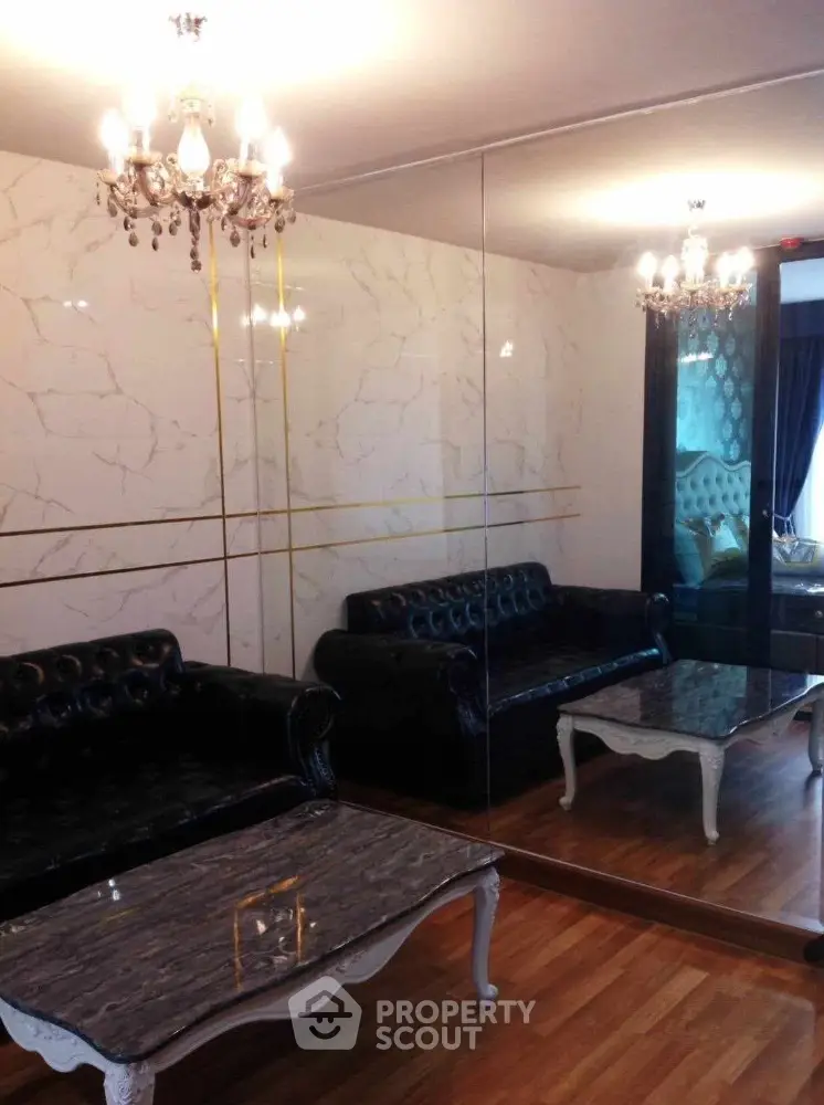 Luxurious living room with elegant chandeliers and mirrored walls