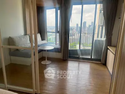 Modern apartment with stunning city view and cozy seating area on balcony.