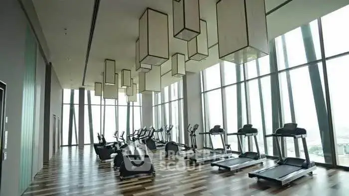 Luxurious high-rise gym with panoramic city views and modern equipment.