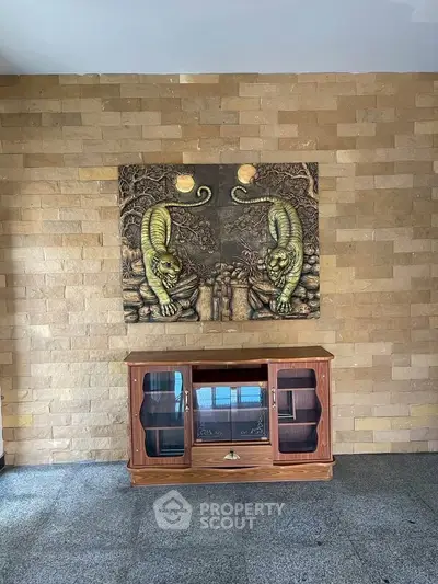 Elegant interior with artistic wall decor and vintage wooden cabinet, perfect for stylish living spaces.