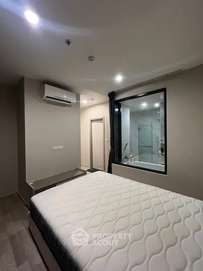 Modern bedroom with large window and air conditioning unit