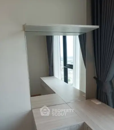 Modern bedroom with stylish vanity mirror and city view