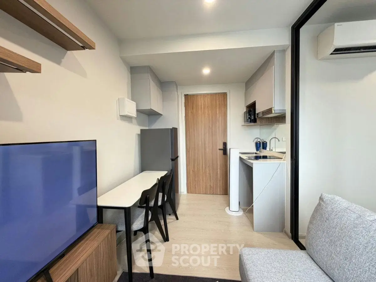 Modern compact living room with open kitchen and sleek furniture