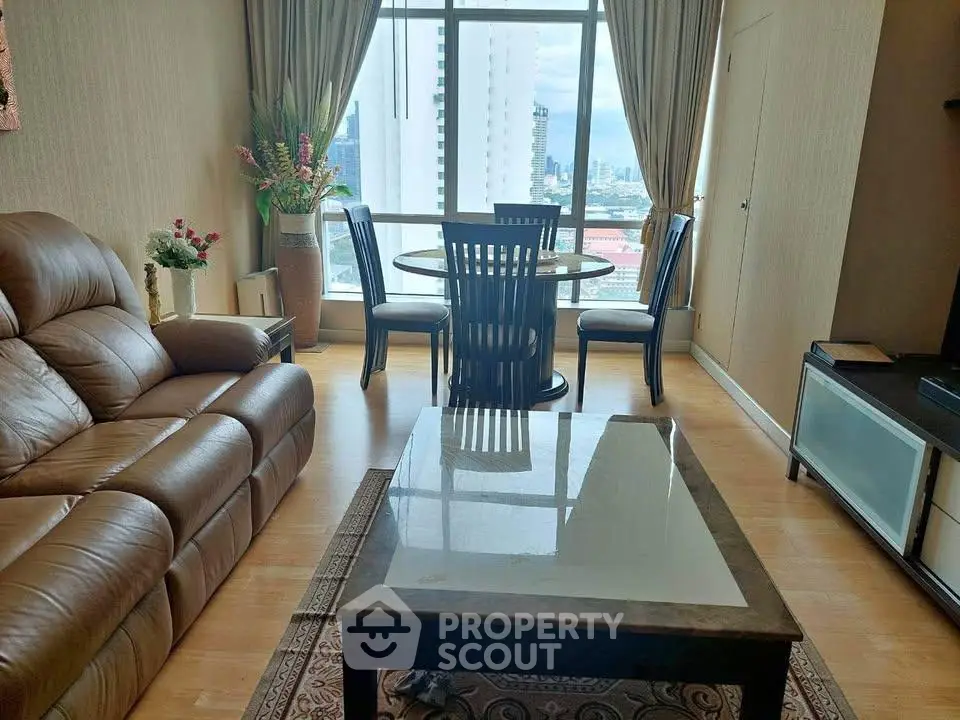 Stylish living room with leather sofa, elegant dining set, and city view from large window.