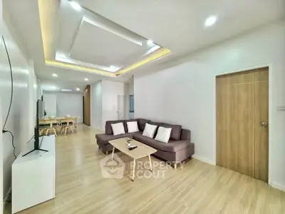 Spacious modern living room with stylish ceiling design and cozy seating area.