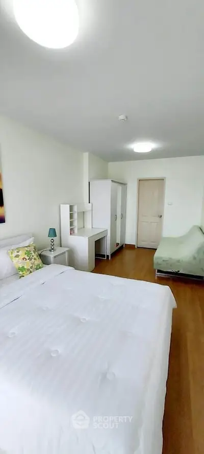 Spacious bedroom with modern furnishings and natural light