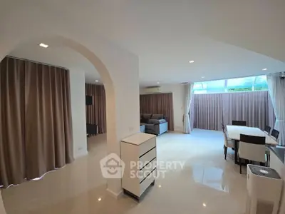 Spacious open-plan living and dining area with modern decor and natural light.