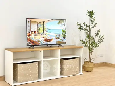 Modern living room with stylish TV stand and decor plant