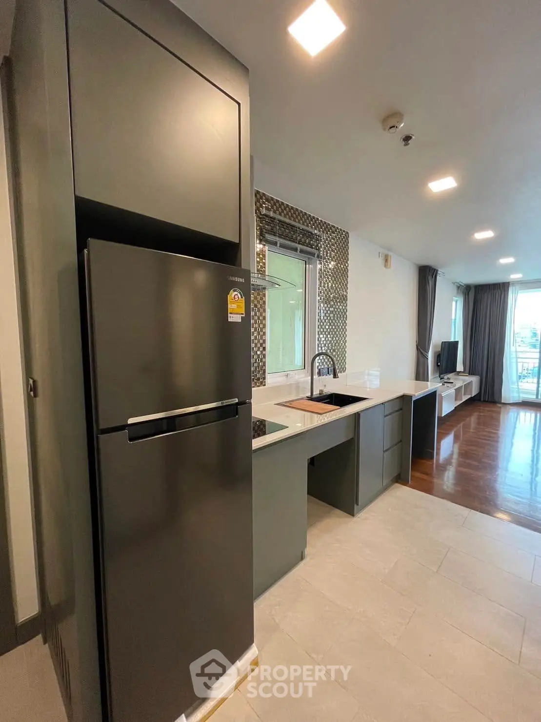Modern kitchen with sleek appliances and open layout in stylish apartment