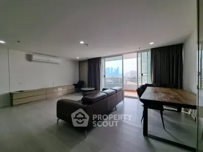 Spacious modern living room with city view and balcony access