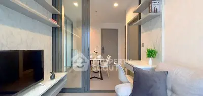 Modern living room with sleek design and dining area, featuring stylish decor and neutral tones.