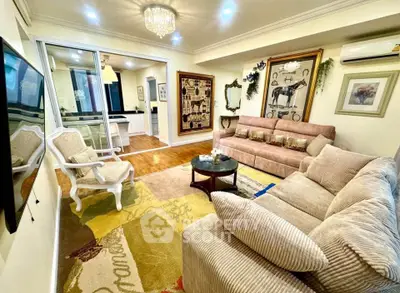 Luxurious living room with elegant decor and plush seating in a modern apartment.