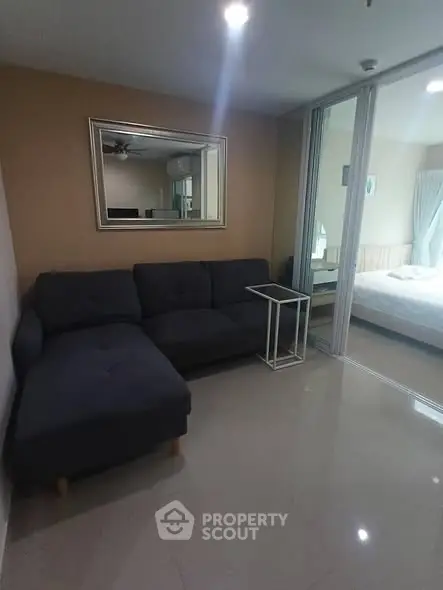 Modern living room with sleek sectional sofa and mirrored wall accent