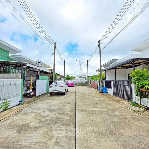 Charming residential street with modern houses and parked cars, showcasing suburban living.