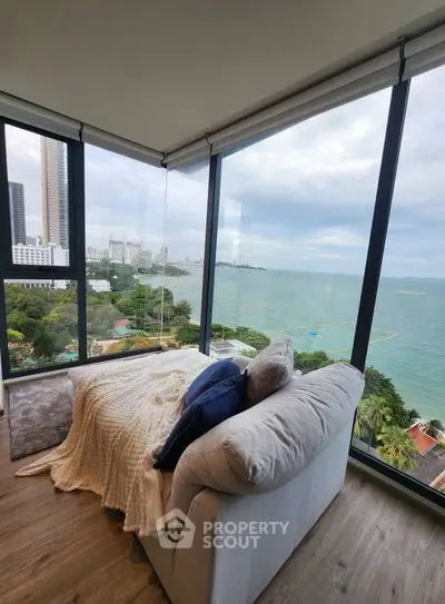 Luxurious corner unit with stunning ocean view from floor-to-ceiling windows.