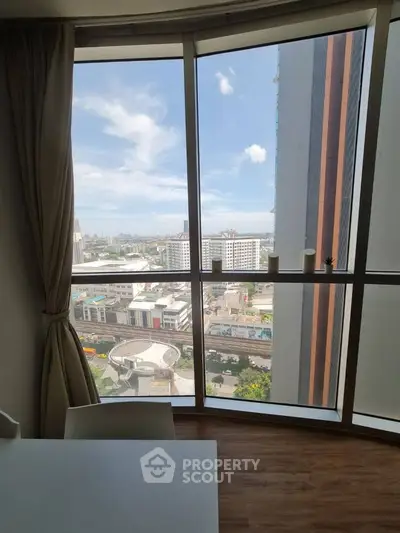 Stunning cityscape view from high-rise apartment window with modern decor