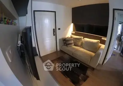 Cozy living room with modern decor and comfortable seating in a stylish apartment.