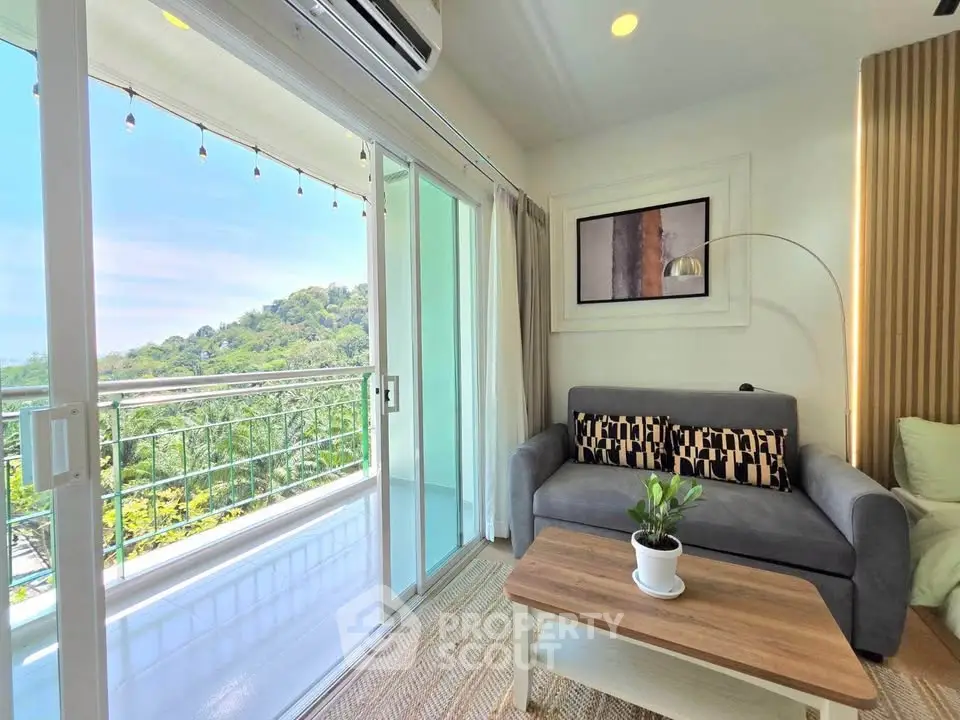 Charming living room with balcony offering stunning nature views, perfect for relaxation and entertaining.