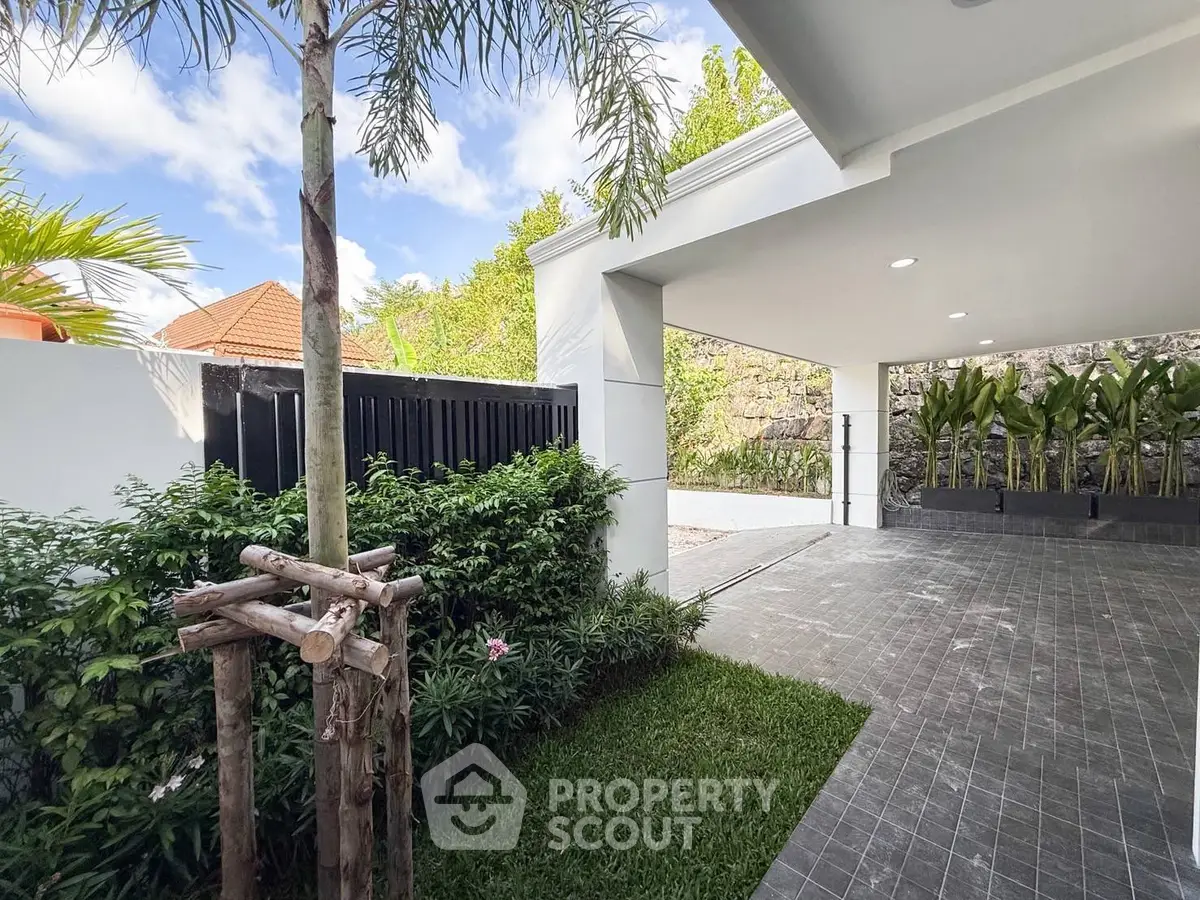 Spacious modern driveway with lush greenery and sleek design.