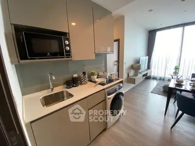 Modern kitchen with sleek cabinetry, integrated appliances, and open layout in stylish apartment.