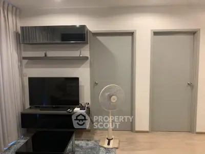 Modern living room with sleek TV setup and stylish shelving, perfect for contemporary living.