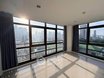 Spacious corner unit with panoramic city views and abundant natural light.