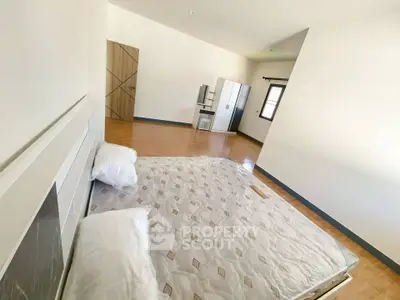 Spacious bedroom with minimalist design and ample natural light