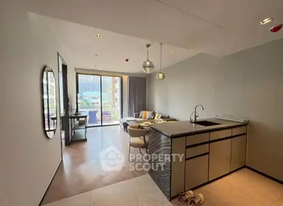 Modern open-plan living room with kitchen and balcony access