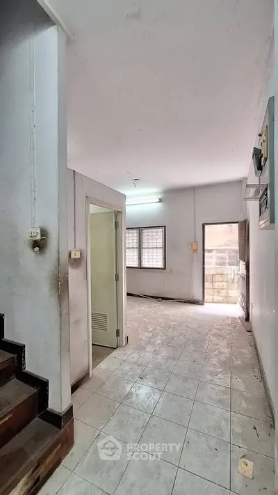 Spacious entryway with tiled flooring and staircase in a residential property