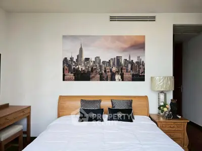 Elegant bedroom with cityscape artwork and stylish wooden furniture