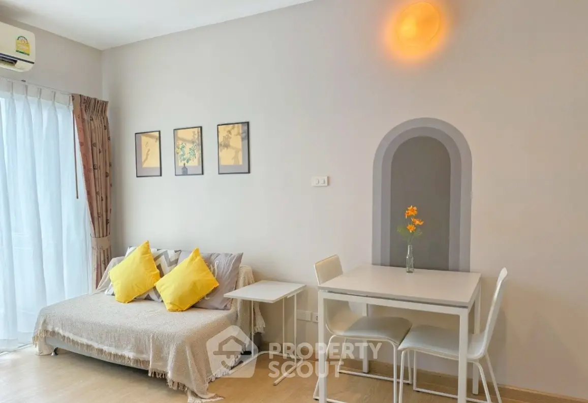 Charming living room with cozy sofa, dining table, and bright decor